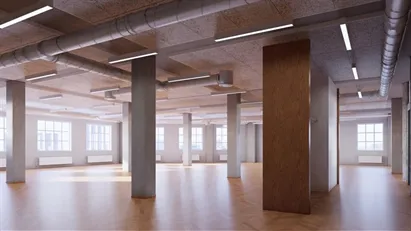 Kontor med taghave, byliv og havneudsigt